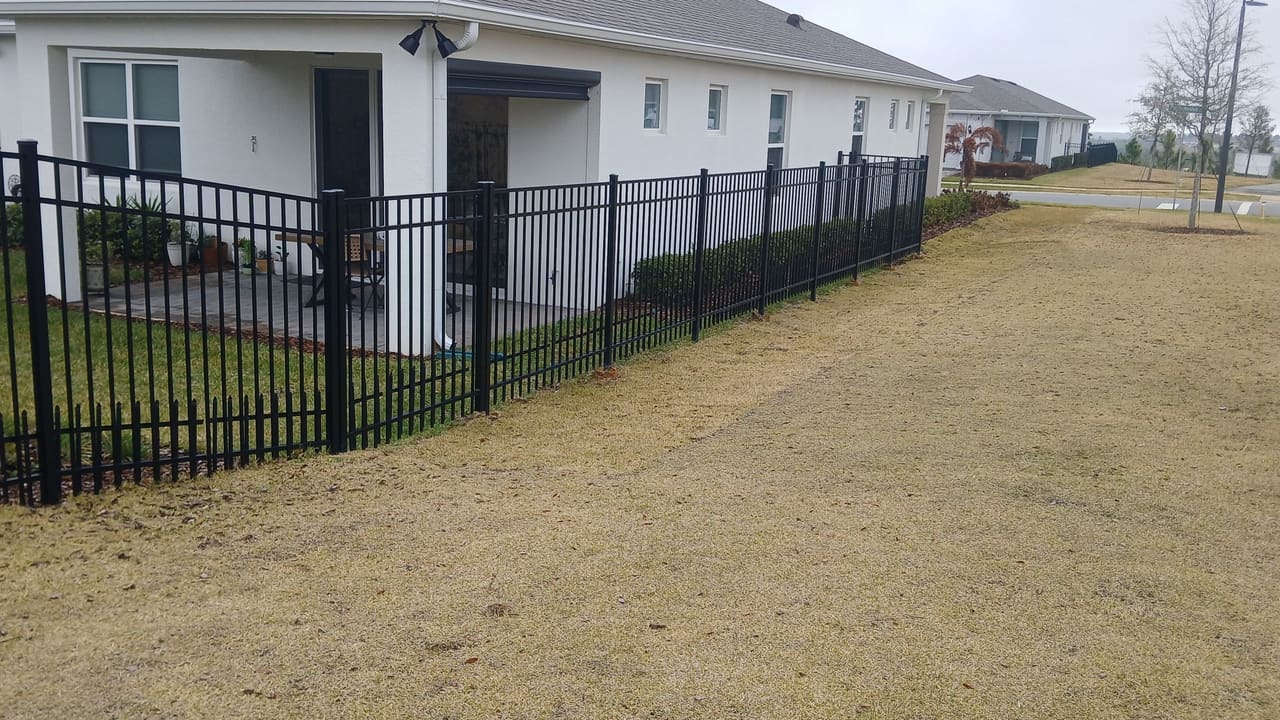 A black aluminium fence run installed by Marquez Yera Fence along a street of Orlando houses
